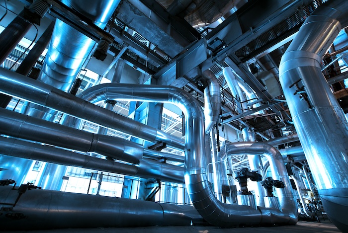 Equipment, cables and piping as found inside of  industrial power plant